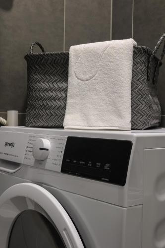 a washing machine with towels on top of it at SPA Studio Apartment SPApartman in Rijeka