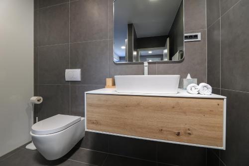 a bathroom with a toilet and a sink and a mirror at SPA Studio Apartment SPApartman in Rijeka