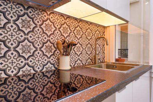 une cuisine avec un évier et un plan de travail dans l'établissement Élégant appartement 1 chambre pour 4 personnes au cœur de Paris, à Bastille, à Paris