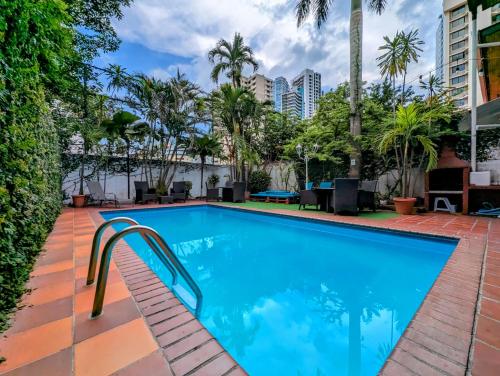 a swimming pool with a stairway leading to a resort at Hostal Yoha in Panama City