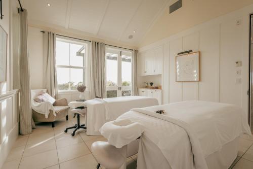 a hospital room with two beds and a window at Rosewood Cape Kidnappers in Te Awanga