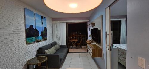 a living room with a couch and a television at VG Sun Cumbuco Sea Breeze Vista Mar in Cumbuco