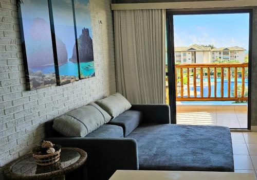 a living room with a couch and a balcony at VG Sun Cumbuco Sea Breeze Vista Mar in Cumbuco