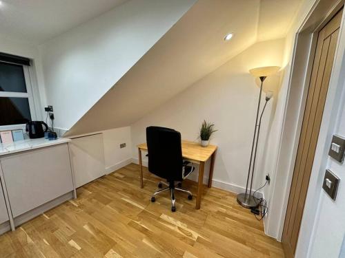 an office with a desk and a chair in a room at Studio near Heathrow in West Drayton