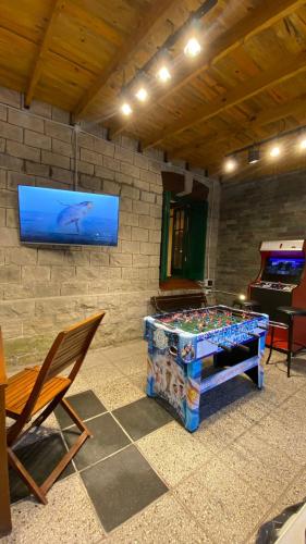 a room with a ping pong table and a television at Hotel Boutique Calash in Mar del Plata
