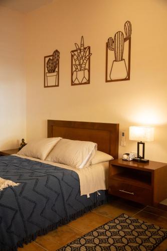a bedroom with a bed and a table with a lamp at Estancia 102 in La Paz