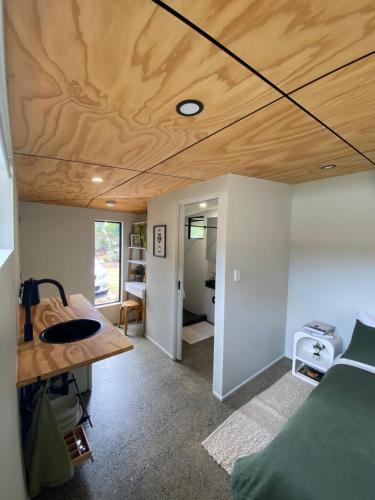 a room with a bed and a wooden ceiling at Central Gem in Dunsborough