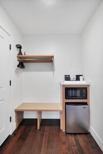a small kitchen with a table and a microwave at Summit Lofts Boutique Hotel in Mount Shasta