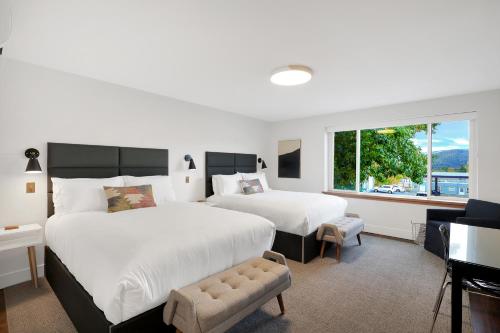 a hotel room with two beds and a window at Summit Lofts Boutique Hotel in Mount Shasta