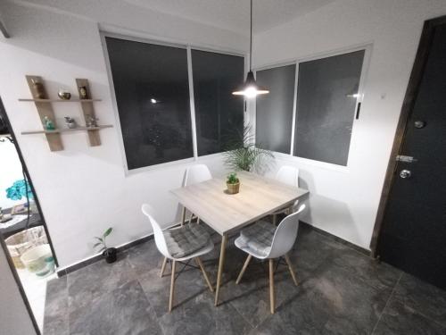 a dining room with a wooden table and chairs at Hospedaje Estrella de Luna in Bogotá