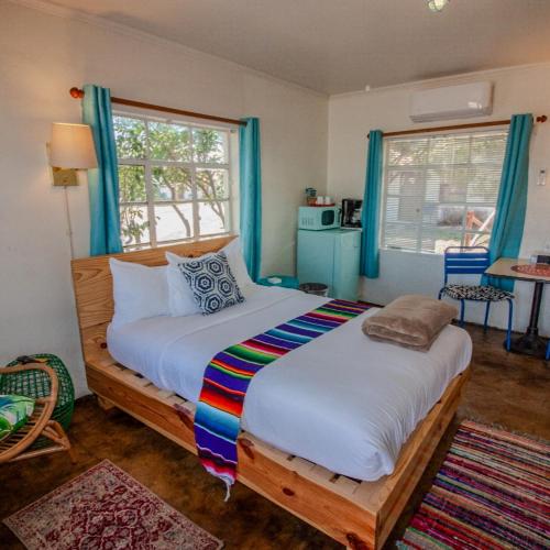 a bedroom with a large bed with a colorful blanket at Antelope Lodge in Alpine