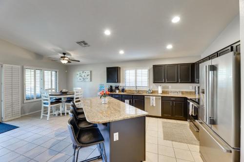 a large kitchen with a counter and a refrigerator at Pool, Hot Tub and Patio Mesa Oasis Desert Getaway in Mesa