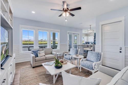 a living room with a couch and chairs and a tv at Nauti Captain in Port Aransas