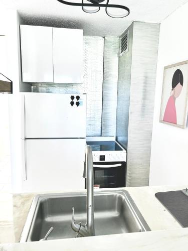 a kitchen with a sink and a refrigerator at Luquillo Beach & Ocean Fresh in Luquillo