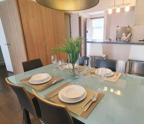 a dining room table with plates and wine glasses at On Paseo de la Reforma, great location, luxurious, pool, gym in Mexico City