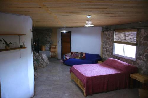 Ένα ή περισσότερα κρεβάτια σε δωμάτιο στο Refugio de Ángeles