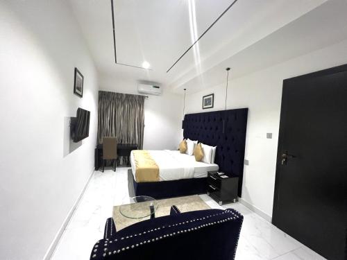 Habitación de hotel con cama y silla en Riviera Hotel, Apartments & Resorts, en Lekki