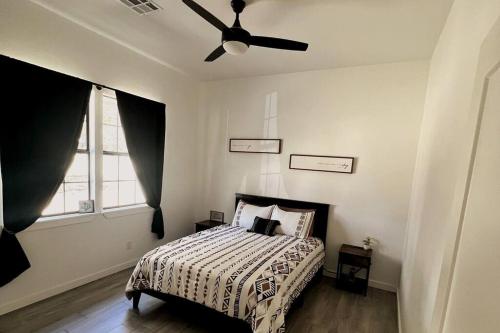 a bedroom with a bed with a ceiling fan at *NEW* Beautiful LakeSide #2 Home in Porum