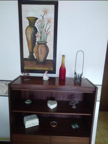 a wooden dresser with vases on top of it at Atlántico Peatonal in Necochea