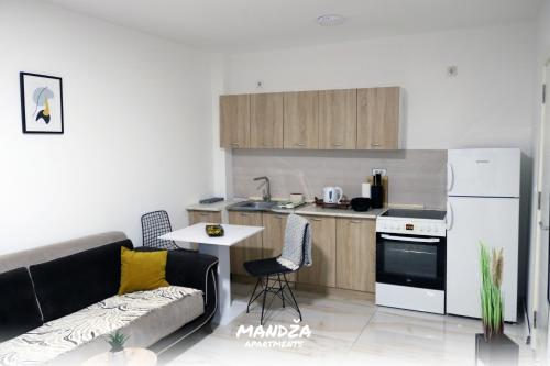 a living room with a couch and a kitchen at Mandza in Novi Pazar