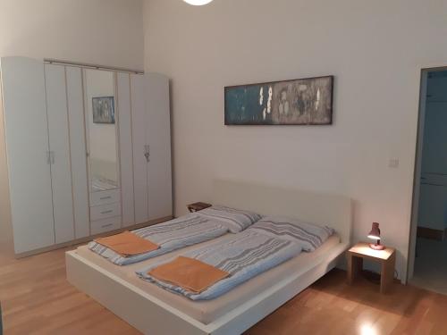a bed in a white room with at Apartment Dahlia Vienna in Vienna