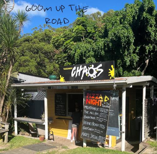 a restaurant with a sign that reads open up the road at THE MAINSTAY Farmstay - book one of 4 houses or all 4, minutes to Seal Rocks! in Neranie