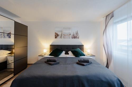 1 dormitorio con 1 cama grande y 2 almohadas en Modern - ruhige Lage - zentrumsnah - 2-Zimmer Apartment, en Horb am Neckar
