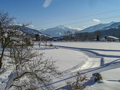 a snow covered road with mountains in the background at Panoramahaus Itter in Itter