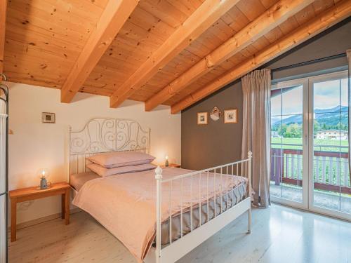 a bedroom with a bed and a large window at Panoramahaus Itter in Itter