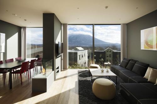 a living room with a couch and a table at Terrazze in Kutchan