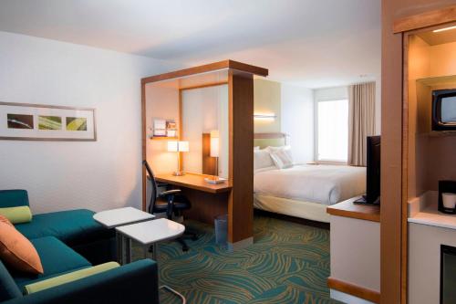 a hotel room with a bed and a desk at SpringHill Suites by Marriott Wisconsin Dells in Wisconsin Dells