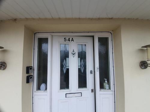 a front door of a house with the number at Eastwood Rooms in Goodmayes
