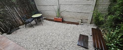 a patio with a table and a table and chairs at Nuestra Recova en Pilar BsAs in Pilar