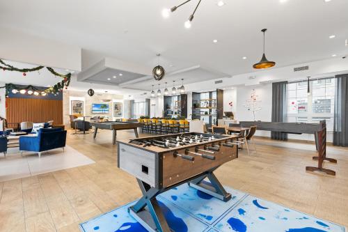 a living room with a ping pong table in the middle at Modern 2BR 2BA Condo Sleeps 8 with Gym Laundry 20 Min to NYC in Jersey City