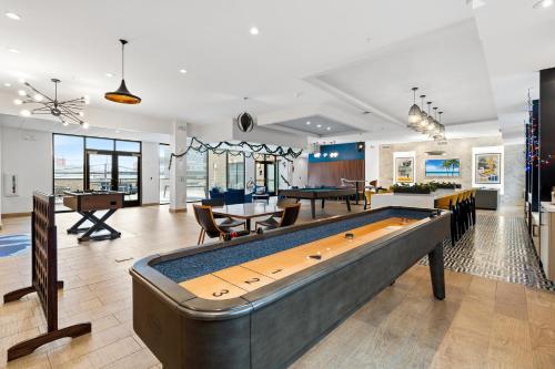 a large living room with a pool table at Modern 2BR 2BA Condo Sleeps 8 with Gym Laundry 20 Min to NYC in Jersey City