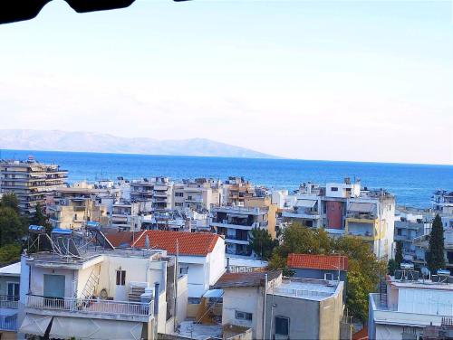 a view of a city with buildings and the ocean at Maria's sea view condo in Kavala