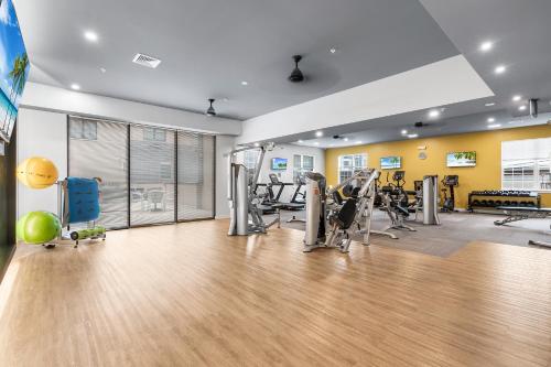 a gym with treadmills and machines in a room at Modern 2BR 2BA Condo Sleeps 8 with Gym Laundry 20 Min to NYC in Jersey City