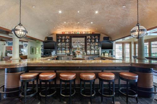 a bar with brown stools in a restaurant at Omni Scottsdale Resort & Spa at Montelucia in Scottsdale