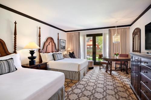 a hotel room with two beds and a desk at Omni Scottsdale Resort & Spa at Montelucia in Scottsdale