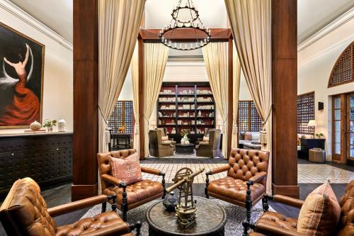 a living room with leather furniture and a library at Omni Scottsdale Resort & Spa at Montelucia in Scottsdale