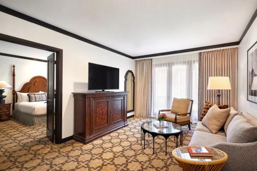 a living room with a couch and a tv and a bed at Omni Scottsdale Resort & Spa at Montelucia in Scottsdale