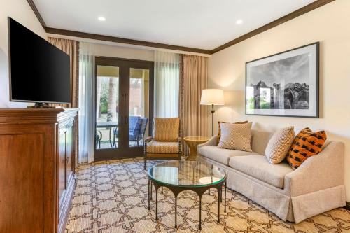 a living room with a couch and a tv at Omni Scottsdale Resort & Spa at Montelucia in Scottsdale