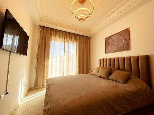 a bedroom with a large bed and a window at Rabat, Hassan Downtown: Tramway, sunshine, privacy in Rabat
