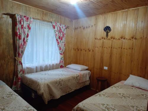 En eller flere senger på et rom på Cabaña la Esquina