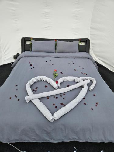 ein Bett mit einem Herz aus Kaffeebohnen in der Unterkunft Nuit insolite dans une bulle avec jacuzzi privatif 