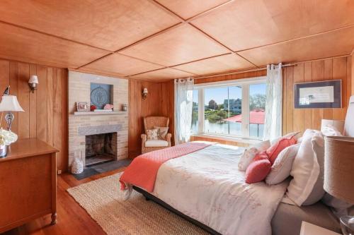 a bedroom with a large bed and a fireplace at Salt Pond Sunrise View & 5 min to beach, sleeps 7 in Charlestown