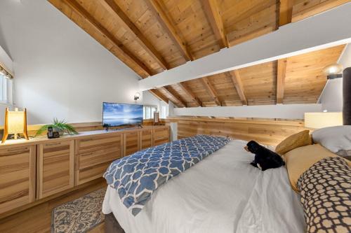 a bedroom with a bed and a flat screen tv at Carnelian Woods # 59 - 2 BR Carnelian Bay Retreat - Minutes to Lake w HOA Amenities in Carnelian Bay