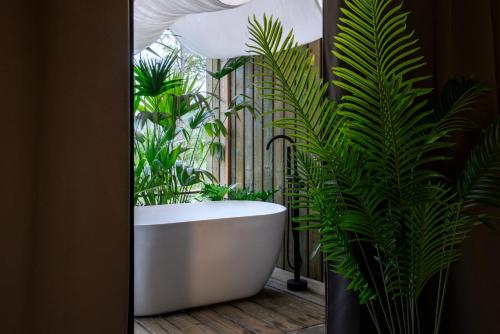 a bathroom with a bath tub and plants at Good Stand in Suao