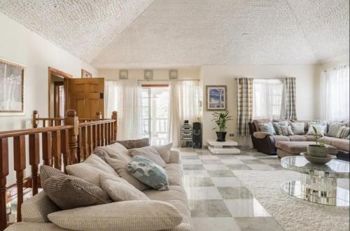 a living room with a couch and a table at Joyful Ambiance Retreat in Bushy Park