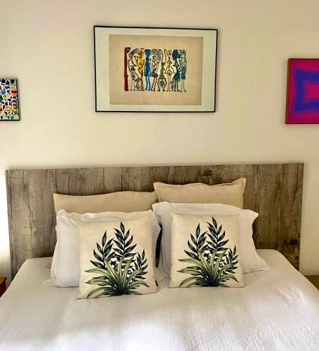 a bedroom with a bed with two plants on it at Casa Irauna in Sao Paulo